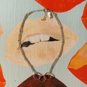 Silver multi-strand necklace with unity circles.